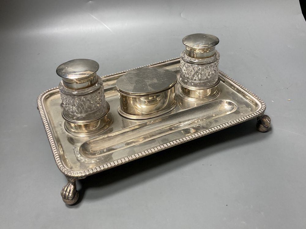 A late Victorian silver rectangular inkstand, with two mounted glass wells and central compartment